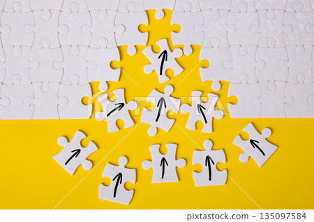 Puzzle pieces forming upward arrow growth strategy Puzzle pieces forming upward arrow growth strategy 135097584