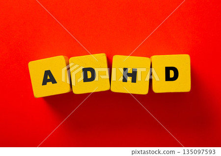 Adhd letters forming word on red background Adhd letters forming word on red background 135097593