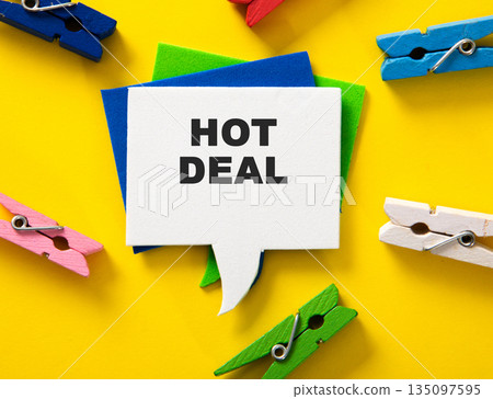 Hot deal message on speech bubble with colorful clothespins Hot deal message on speech bubble with colorful clothespins 135097595