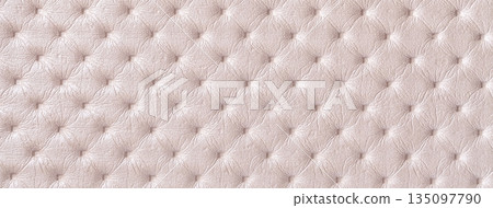 Pastel beige leather texture with capitone pattern, macro background of cream retro Chesterfield vintage textile fabric Pastel beige leather texture with capitone pattern, macro background of cream retro Chesterfield vintage textile fabric 135097790