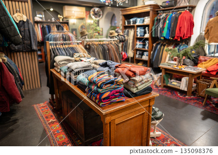 Vintage men's clothing store interior with different kinds of apparel and accessories on display. Vintage men's clothing store interior with different kinds of apparel and accessories on display. 135098376
