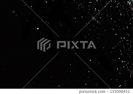 Snow particles overlay on black background Snow particles overlay on black background 135098452