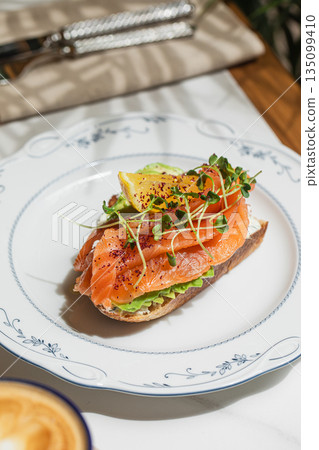 Avocado toast with salmon and lemon 135099410