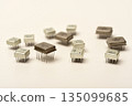 Old chips on a white background. Different electronic chips. Microcircuits in a metal case. 135099685