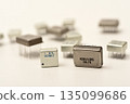 Old chips on a white background. Different electronic chips. Microcircuits in a metal case. 135099686