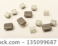 Old chips on a white background. Different electronic chips. Microcircuits in a metal case. 135099687