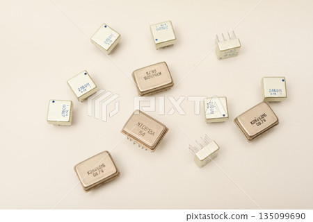 Old chips on a white background. Different electronic chips. Microcircuits in a metal case. Old chips on a white background. Different electronic chips. Microcircuits in a metal case. 135099690