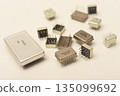 Old chips on a white background. Different electronic chips. Microcircuits in a metal case. 135099692