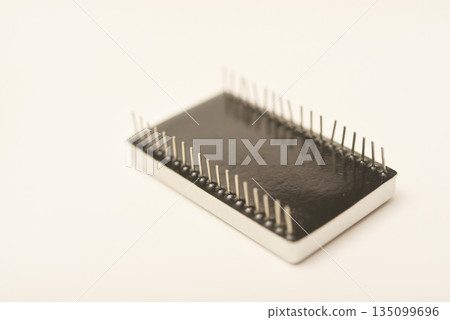 Old chips on a white background. Different electronic chips. Microcircuits in a metal case. 135099696
