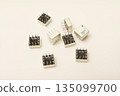 Old chips on a white background. Different electronic chips. Microcircuits in a metal case. 135099700