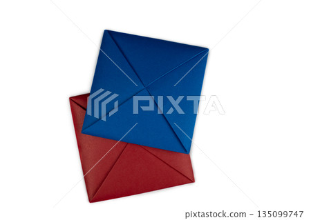 Blue and red paper square for game Ttakchi on white background. Simple, popular Asian game that involves flipping and tossing paper pieces. Ttakji game, isolated. Paper flip cards 135099747