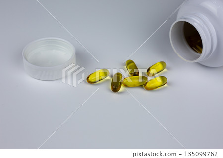 Pills isolated capsules medicine vitamins minerals gel capsules. Fish oil Omega 3 supplement capsules on white background. Omega 3, omega 6. Food supplement oil filled fish oil, flaxseed oil Pills isolated capsules medicine vitamins minerals gel capsules. Fish oil Omega 3 supplement capsules on white background. Omega 3, omega 6. Food supplement oil filled fish oil, flaxseed oil 135099762