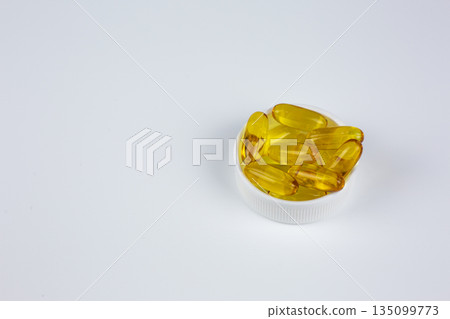 Recommended use of Omega 3 vitamin in gelatin capsule with fish oil. Universal dietary supplement for taking with food. Concept of medical, health and wellness. Vitamins for elderly and young 135099773