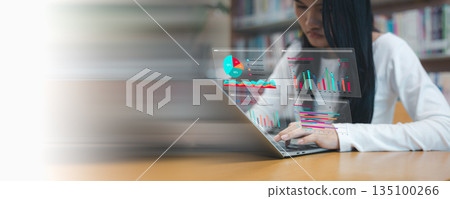 Business woman using laptop with virtual data analysis dashboard. Concept of financial marketing strategy, big data processing and business growth visualization on wooden table. 135100266