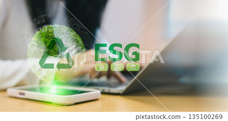 ESG concept for environmental social and governance. Business person using laptop with green earth and recycling icon. Sustainable development and corporate responsibility in digital technology. ESG concept for environmental social and governance. Business person using laptop with green earth and recycling icon. Sustainable development and corporate responsibility in digital technology. 135100269