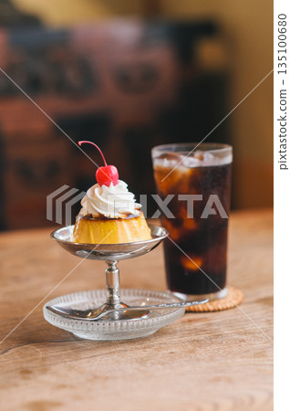 Pudding and iced coffee lined up on a table in a retro coffee shop 135100680