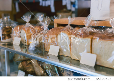 Inside a bakery with rows of wrapped bread 135100698