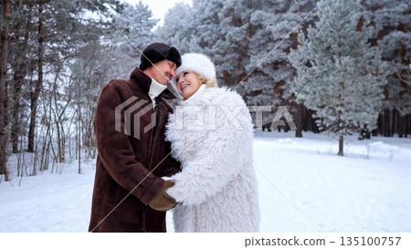 Couple Hugs Outdoors, Romantic Couple Celebrating Marriage During Winter Outdoor Photo Shoot, Brightly Dressed Newlyweds Exchange Warm Embraces Amidst Snowy Trees During Intimate Wedding Photography Couple Hugs Outdoors, Romantic Couple Celebrating Marriage During Winter Outdoor Photo Shoot, Brightly Dressed Newlyweds Exchange Warm Embraces Amidst Snowy Trees During Intimate Wedding Photography 135100757