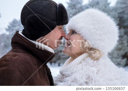 Love In Winter, Partners Embrace In Chilly Snow, Hearts Unite Amid Falling Winter Snowflakes, Romantic Pair Connects Deeply While Surrounded By Coldness And Beauty Of Winter Snowfall 135100837