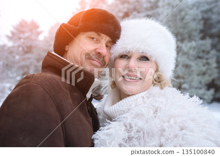 Smiling Pair With Snowy Trees, Couple Smiling Happily Surrounded By Frosty Pine Landscape, Joyful Pair Captured Amidst Snowcovered Pines With Cheerful Expressions And Festive Atmosphere 135100840