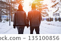 Couple Holding Hands Walking Through Snowy Park, Sunset Backlight Creates Warm Glow, Tall Pines Line Path, Bundled Jackets And Beanies, Peaceful Winter Atmosphere, Intimate Connection And Gentle Pace 135100856