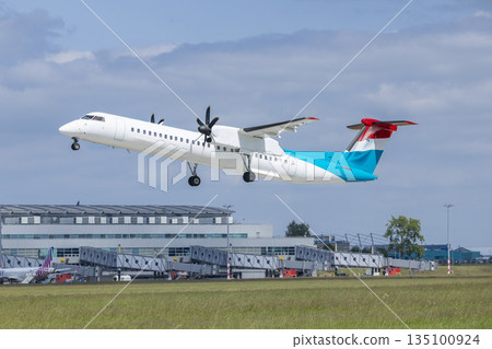 Turboprop airplane flying taking off from airport Turboprop airplane flying taking off from airport 135100924