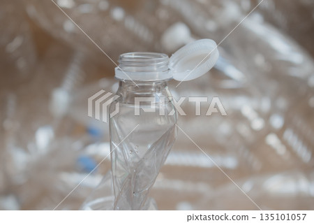 crushed plastic water bottle saving space in cardboard box of materials collected for recycling crushed plastic water bottle saving space in cardboard box of materials collected for recycling 135101057