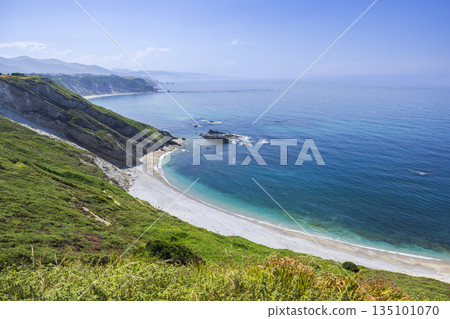 Asturias coastline with beach, green cliffs and clear blue sea 135101070