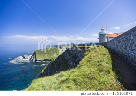 Cudillero lighthouse illuminating rugged Asturias coast in Spain Cudillero lighthouse illuminating rugged Asturias coast in Spain 135101071