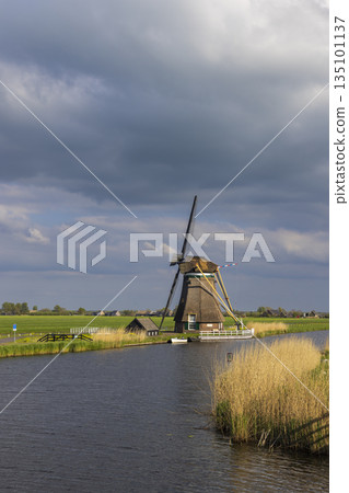 Traditional Dutch windmill standing by canal in Groot Ammers Traditional Dutch windmill standing by canal in Groot Ammers 135101137