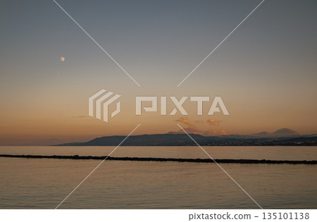Moonlit seascape with soft twilight hues and distant silhouettes Moonlit seascape with soft twilight hues and distant silhouettes 135101138