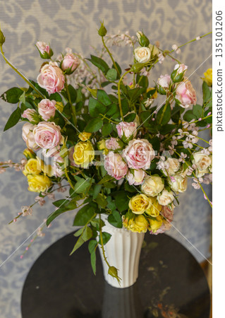 Rose bouquet in vase bringing floral decoration indoors Rose bouquet in vase bringing floral decoration indoors 135101206