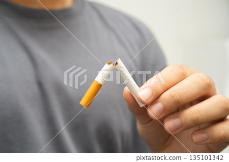 Quit smoking, Asian teenage man breaking destroy cigarette in hand. Quit smoking, Asian teenage man breaking destroy cigarette in hand. 135101342