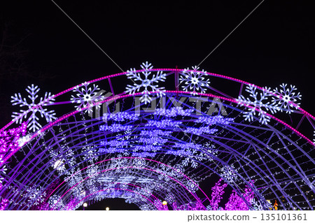 Glowing snowflake arch illuminating winter night festival 135101361