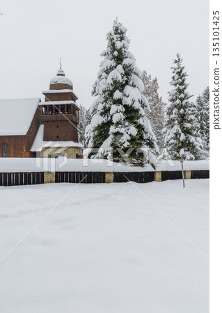 Wooden church and snowy spruces in Svaty Kriz 135101425
