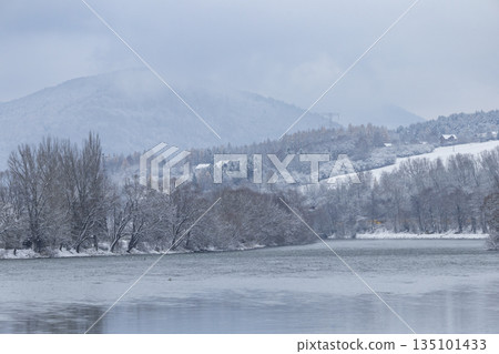 Winter landscape with Vah river and snow covered trees in Strecno 135101433