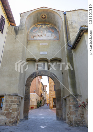Ancient archway fresco opening to historic street in Pienza Ancient archway fresco opening to historic street in Pienza 135101519