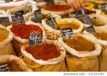 French market selling a variety of colorful spices 135101567