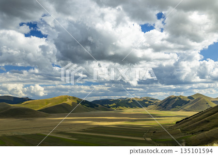 Piano Grande valley with dramatic cloud shadows Piano Grande valley with dramatic cloud shadows 135101594