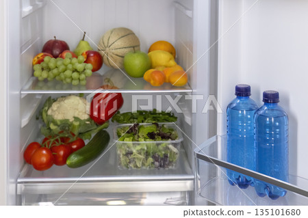 Refrigerator full of fresh healthy fruit and vegetables Refrigerator full of fresh healthy fruit and vegetables 135101680