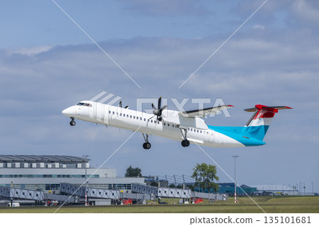 Turboprop airplane taking off from airport runway Turboprop airplane taking off from airport runway 135101681