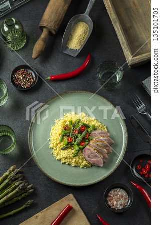 Duck breast with couscous and asparagus, overhead view Duck breast with couscous and asparagus, overhead view 135101705