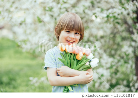 Happy young child holding a bouquet of pastel tulips in a blooming spring garden. Fresh, joyful image perfect for greeting cards, Mothers Day, Easter, spring celebrations, and family themes. Happy young child holding a bouquet of pastel tulips in a blooming spring garden. Fresh, joyful image perfect for greeting cards, Mothers Day, Easter, spring celebrations, and family themes. 135101817