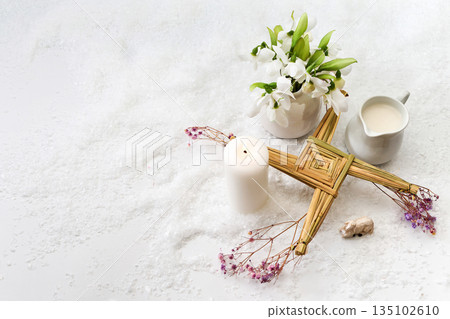 Brigid's cross, snowdrops, candle celebrating imbolc festival Brigid's cross, snowdrops, candle celebrating imbolc festival 135102610