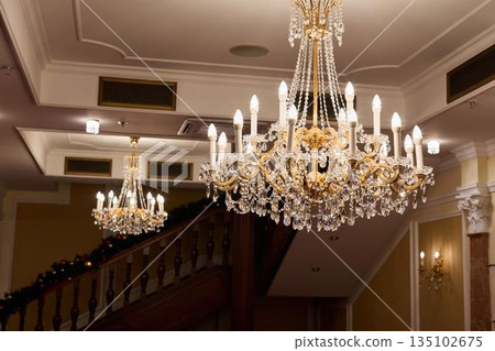 Elegant Reception Area, Formal Entryway With Chandelierlit Stairs And Sophisticated Seating Arrangements 135102675