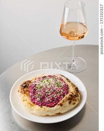 closeup beetroot pizza with rose wine glass, editorial studio closeup beetroot pizza with rose wine glass, editorial studio 135102827