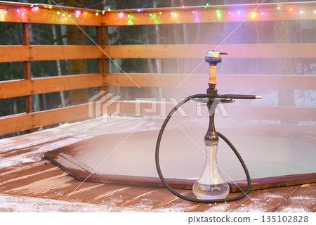 Elegant shisha arrangement amid vibrant lights and cozy ambiance 135102828