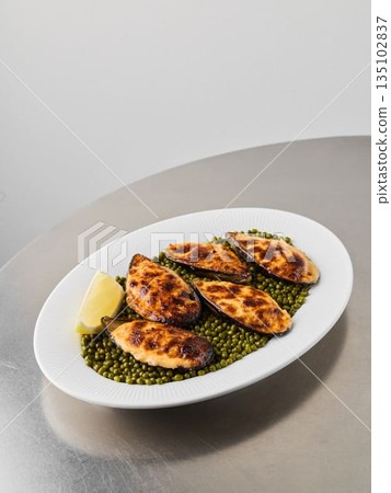 Crispy Baked Mussels Resting on Bright Lentil Bed with Herbs Crispy Baked Mussels Resting on Bright Lentil Bed with Herbs 135102837
