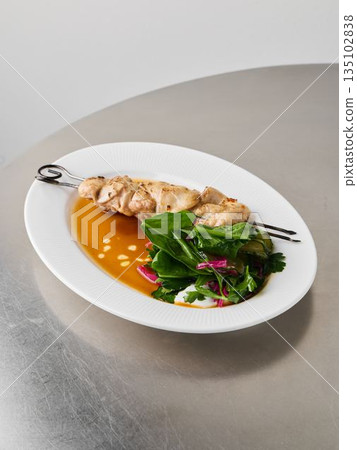 Gourmet fish dish with vibrant sauce and artistic plating Gourmet fish dish with vibrant sauce and artistic plating 135102838