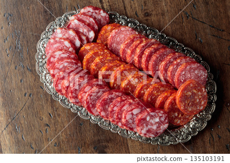 Smoked sausages on a silver tray. Smoked sausages on a silver tray. 135103191